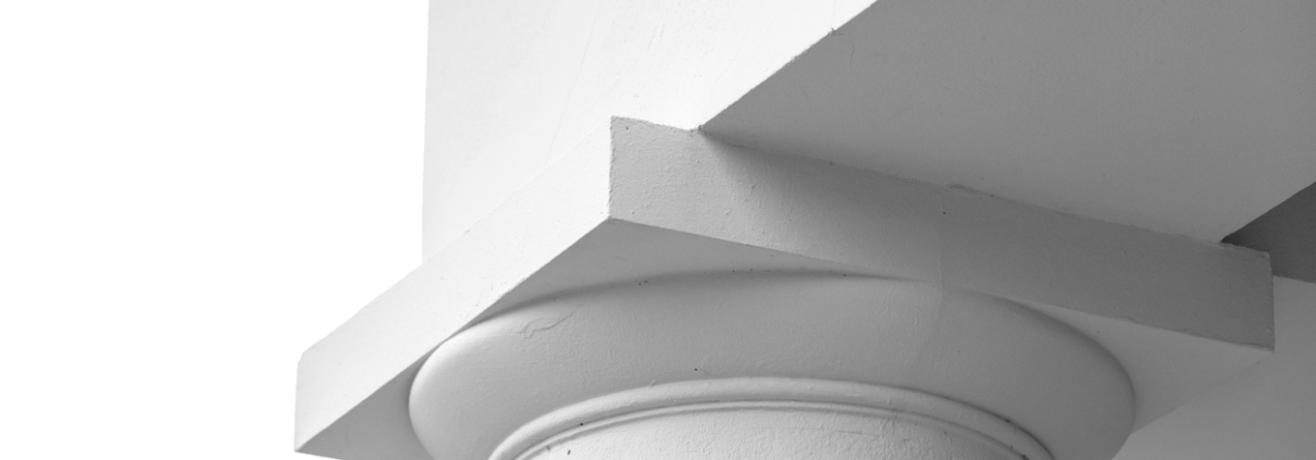 A precise close-up of a white architectural column capital and a geometric beam Rendered column capping moulding